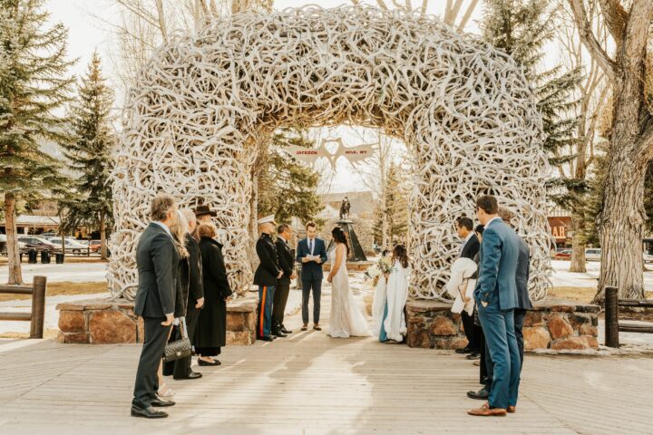 Small gathering around Jackson Hole's Town Center for this wedding ceremony under the antler arch.